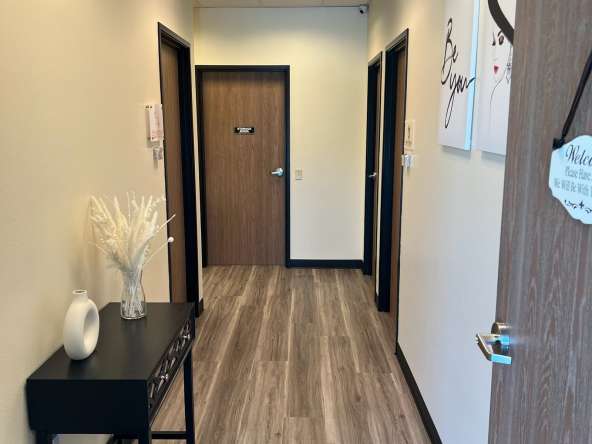 Bright salon rental suite hallway with modern decor and welcoming atmosphere.