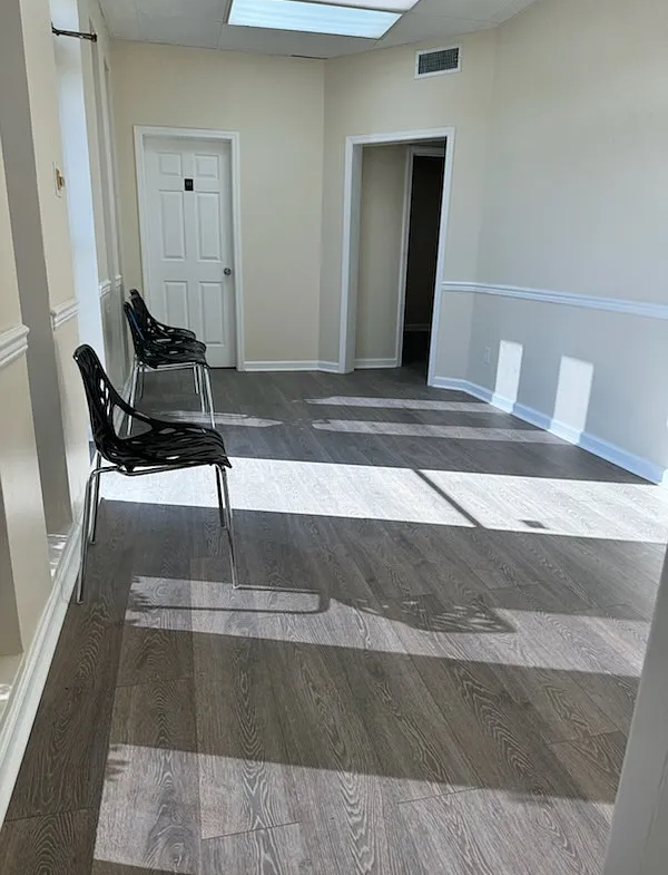 Bright salon interior with chairs, white walls, and natural light for client comfort.