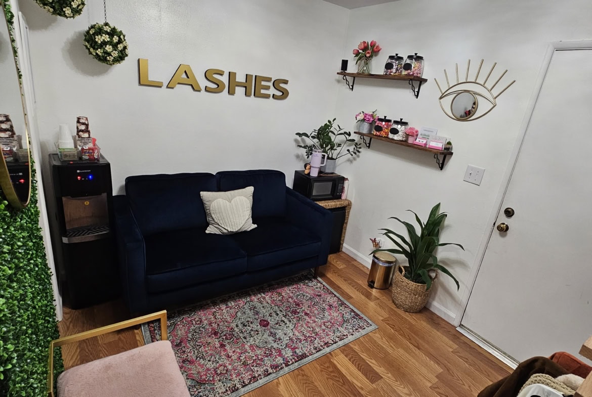 Stylish salon waiting area with comfortable seating and decorative accents.