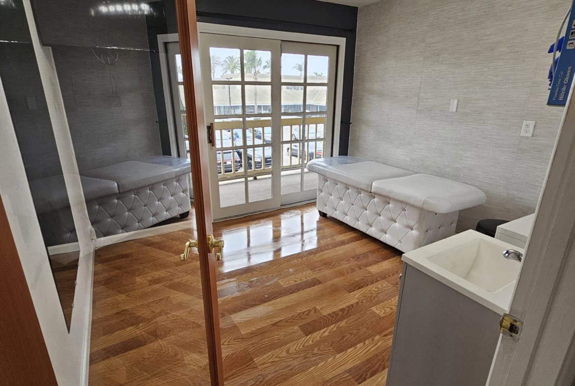 Mirror, treatment beds, and natural light create the perfect salon environment.