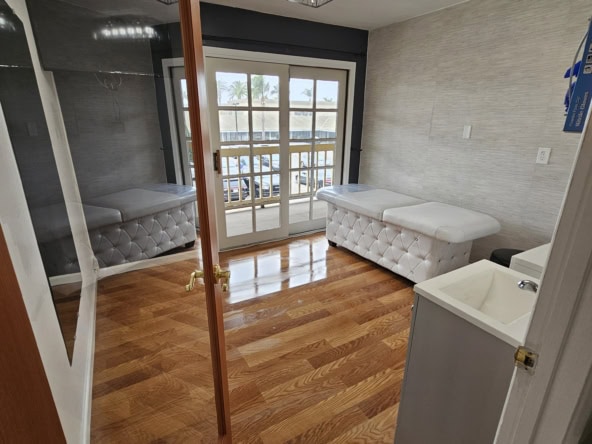 Mirror, treatment beds, and natural light create the perfect salon environment.