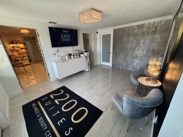 Bright, stylish salon interior featuring comfortable chairs, modern lighting, and a welcoming vibe.