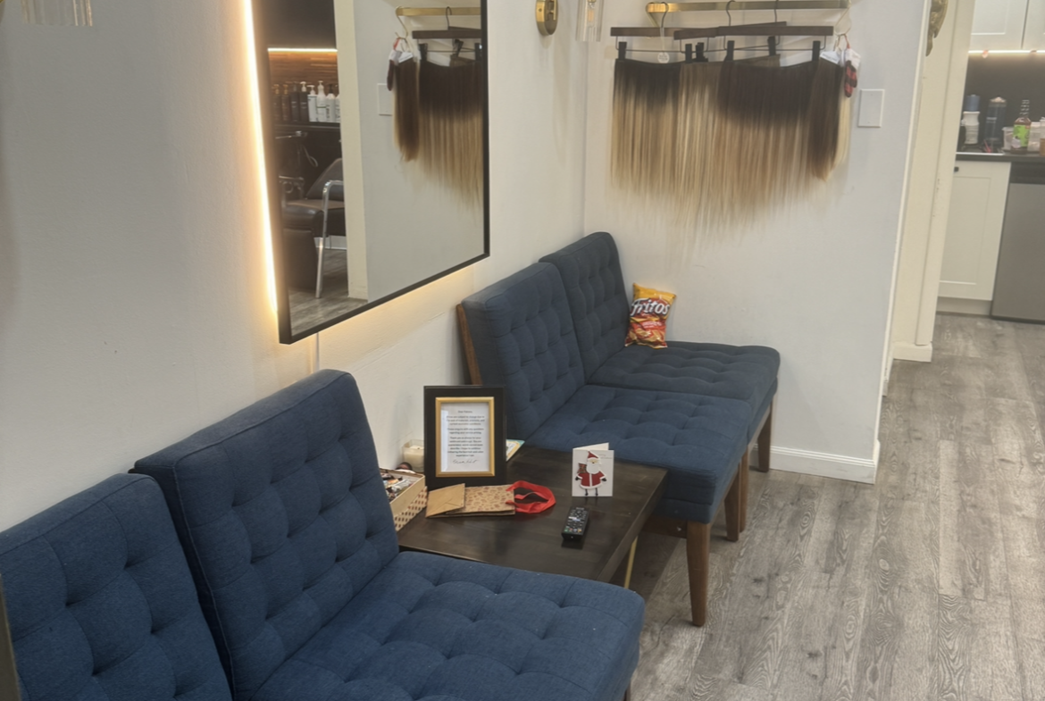 Comfortable blue tufted chairs in salon lobby.