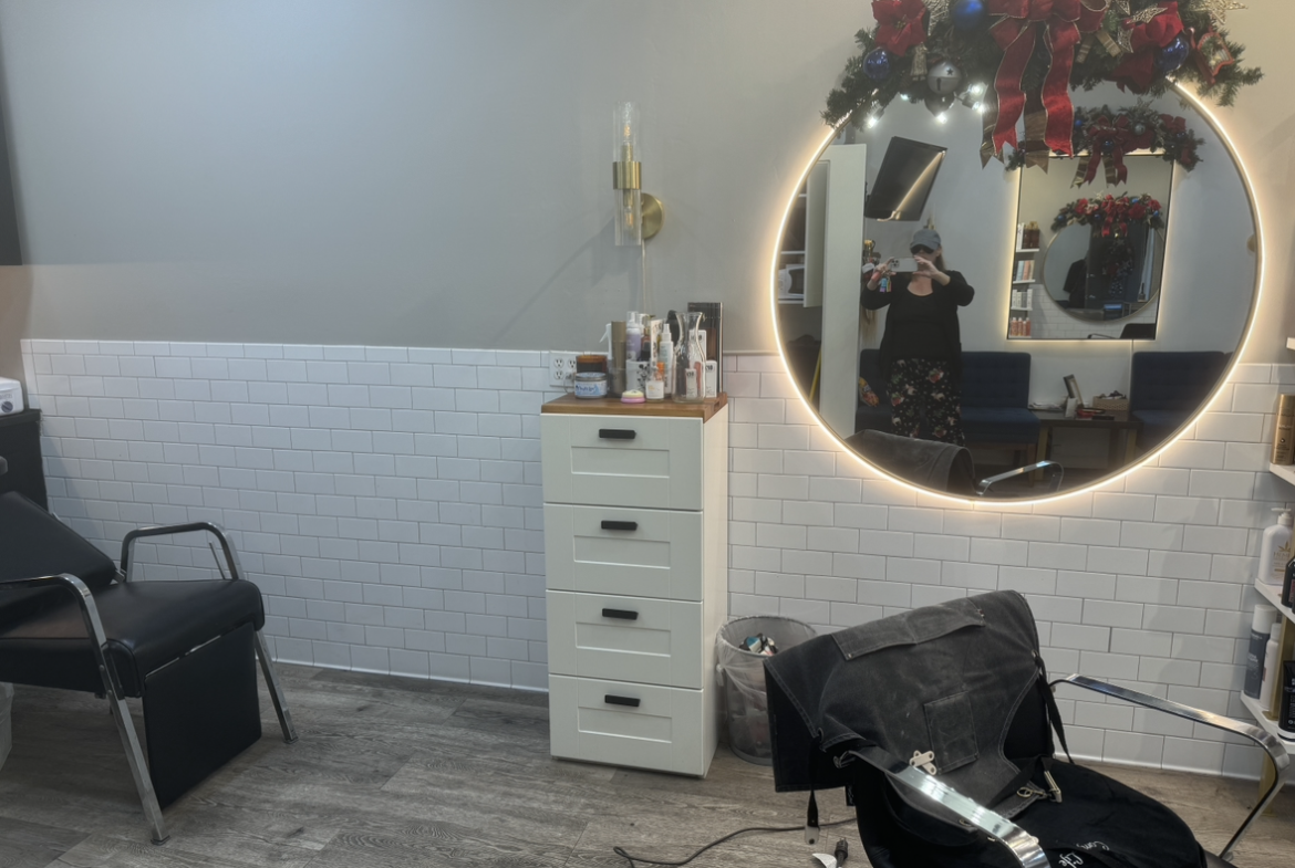 Modern salon reception with Christmas decor and styling station.