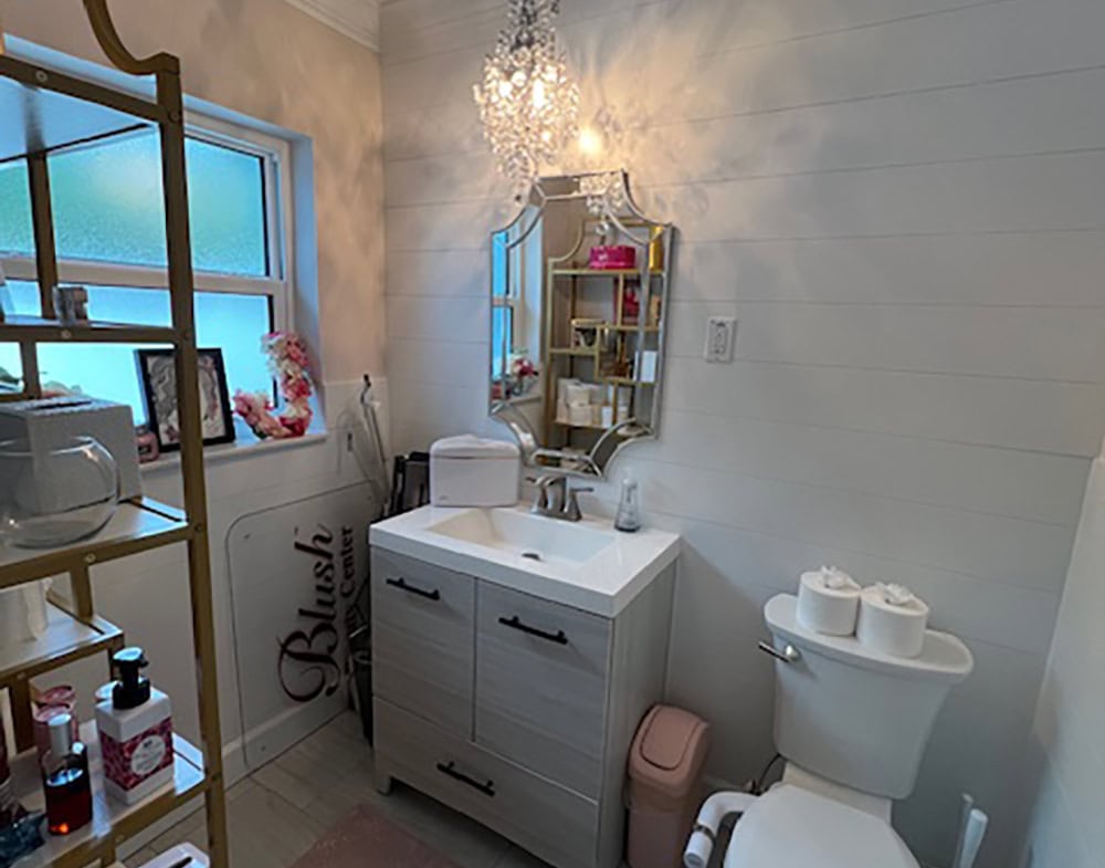 Bright bathroom in salon with elegant lighting and decor features.