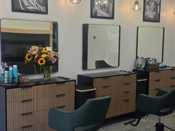Salon interior featuring hair styling chairs, mirrors, and salon accessories.