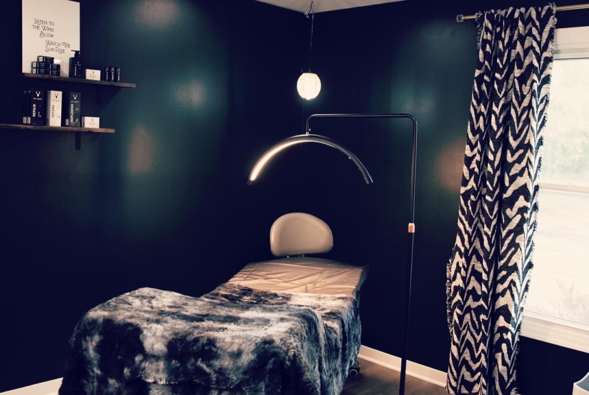 Comfortable massage bed in stylish, professional salon rental environment.