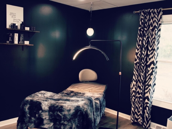 Comfortable massage bed in stylish, professional salon rental environment.