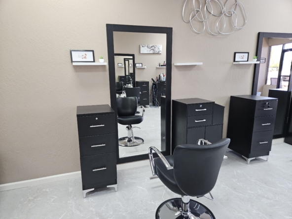 Stylish black salon chairs with mirrors and storage for modern hair styling and beauty services.