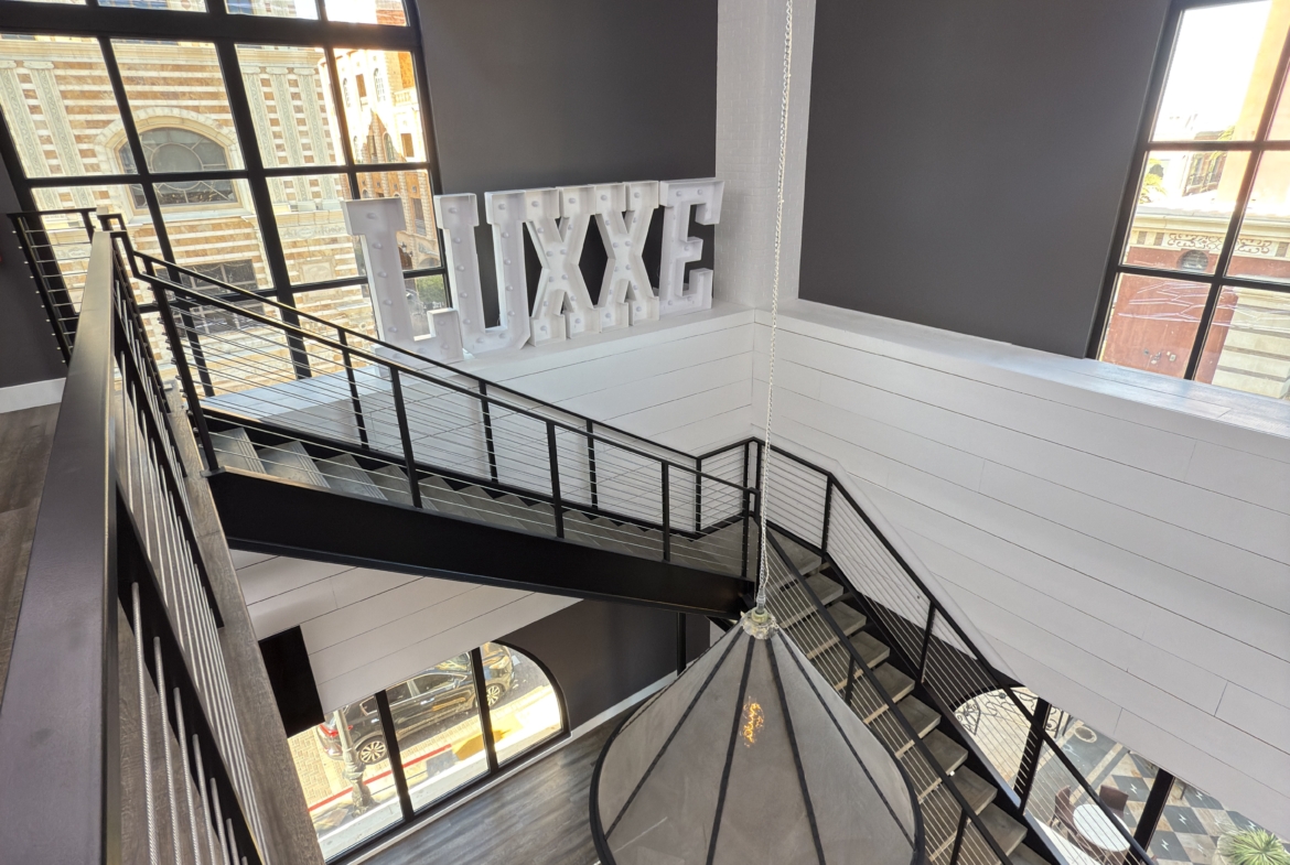 Bright salon interior with big windows, stylish neon sign, and contemporary design.