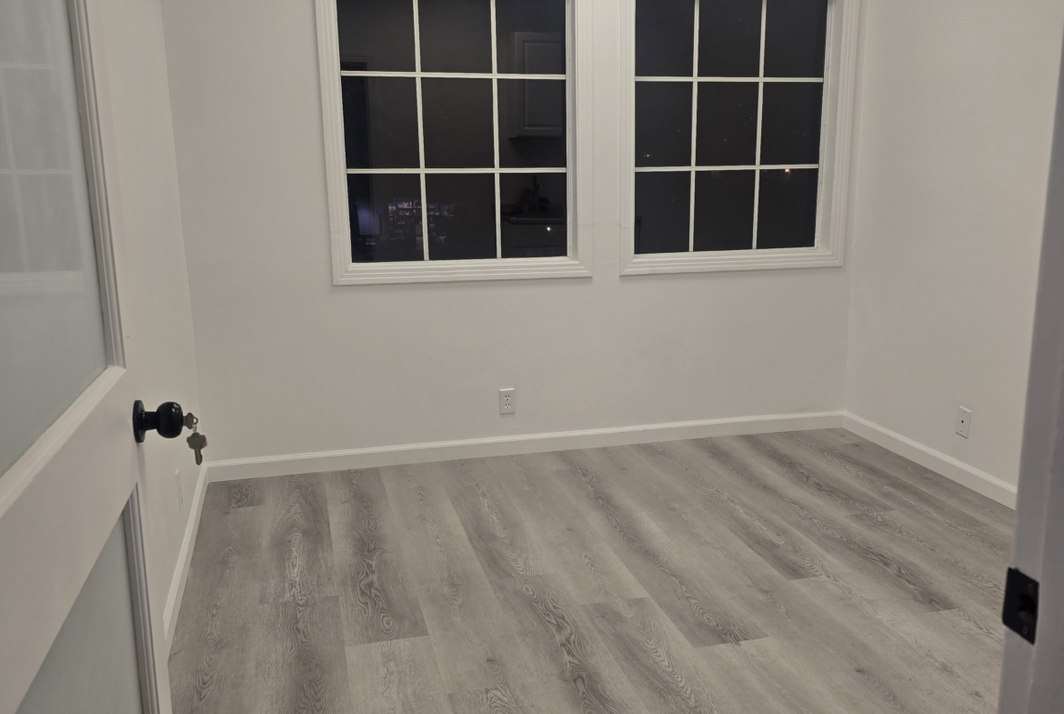 Bright room with large windows and hardwood flooring, ideal for salon or professional use.