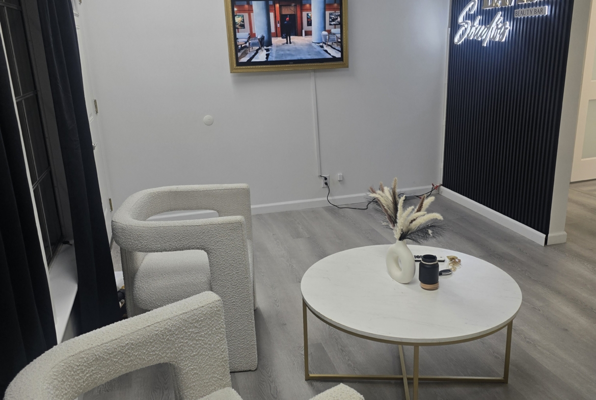 Comfortable salon reception space with stylish chairs and minimalist design.