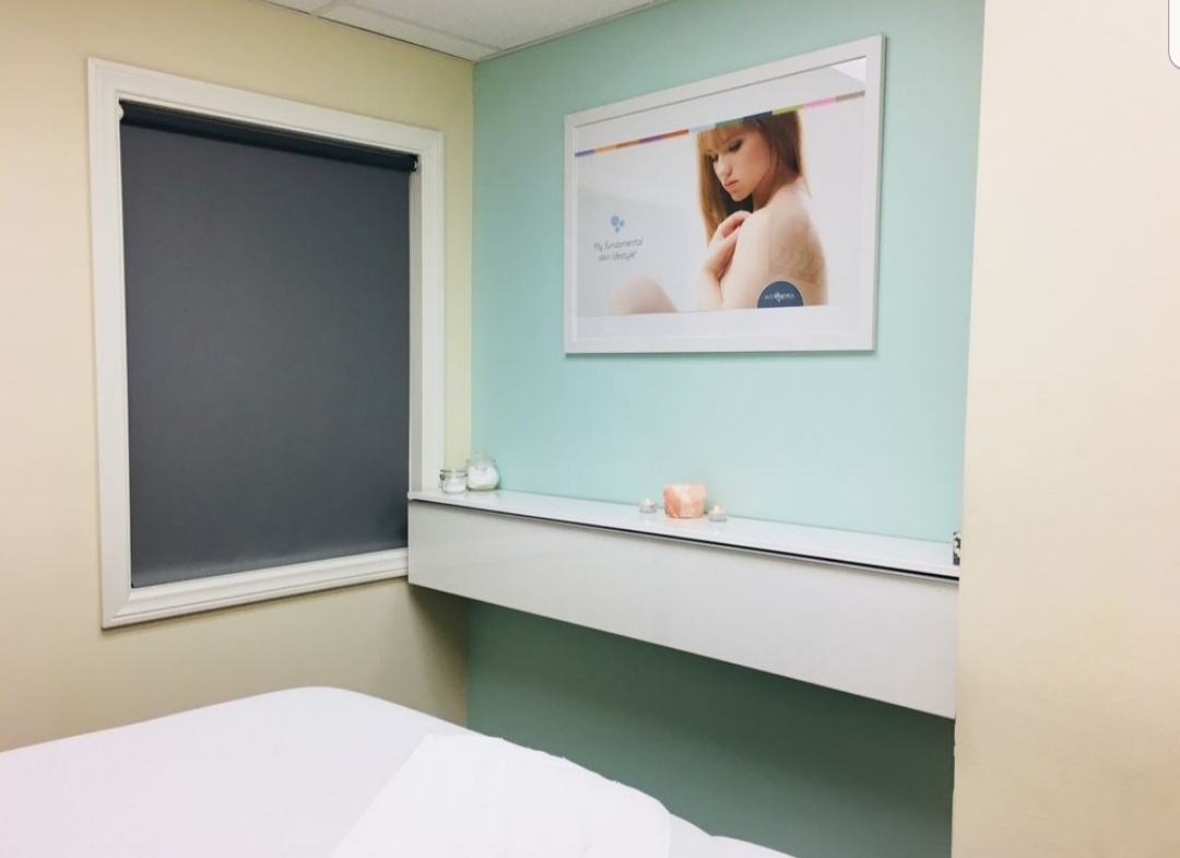 A cozy salon room featuring a relaxing spa ambiance with candles, soft lighting, and calming decor.