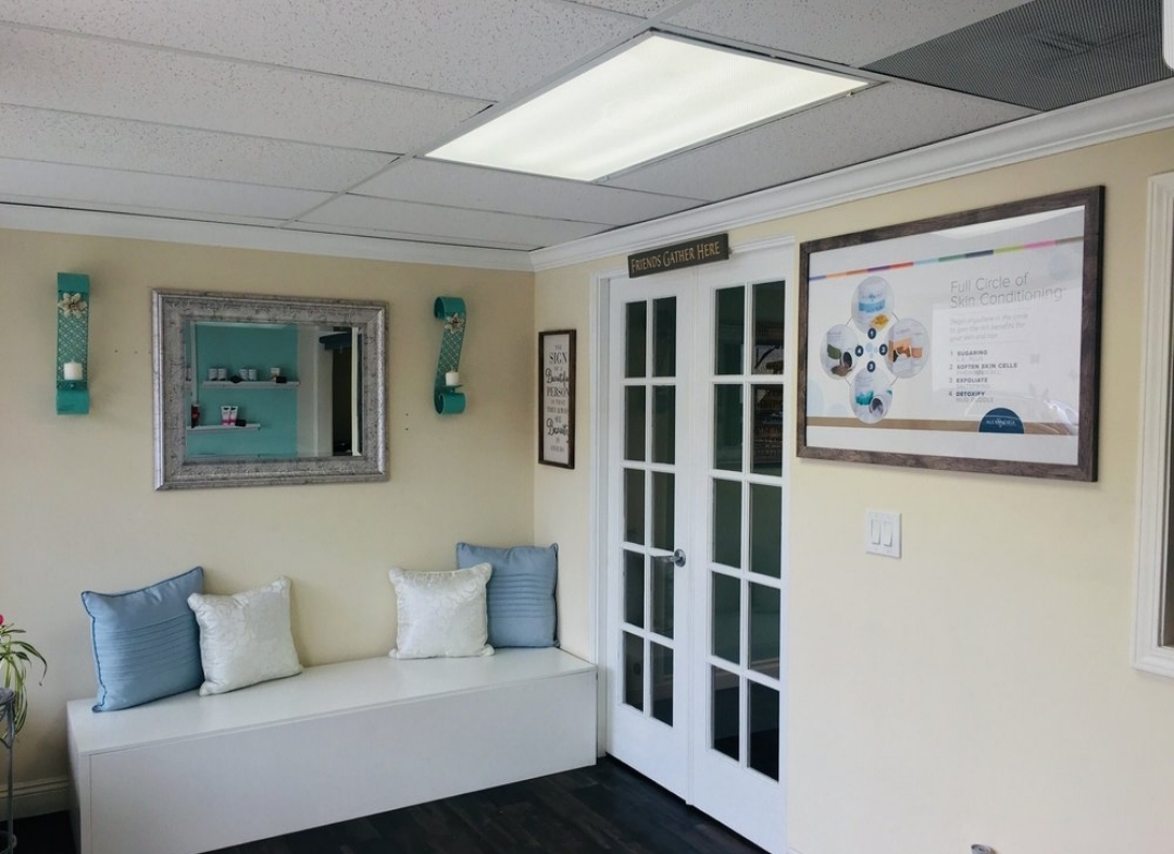 Bright salon interior with comfortable seating and skincare decor.