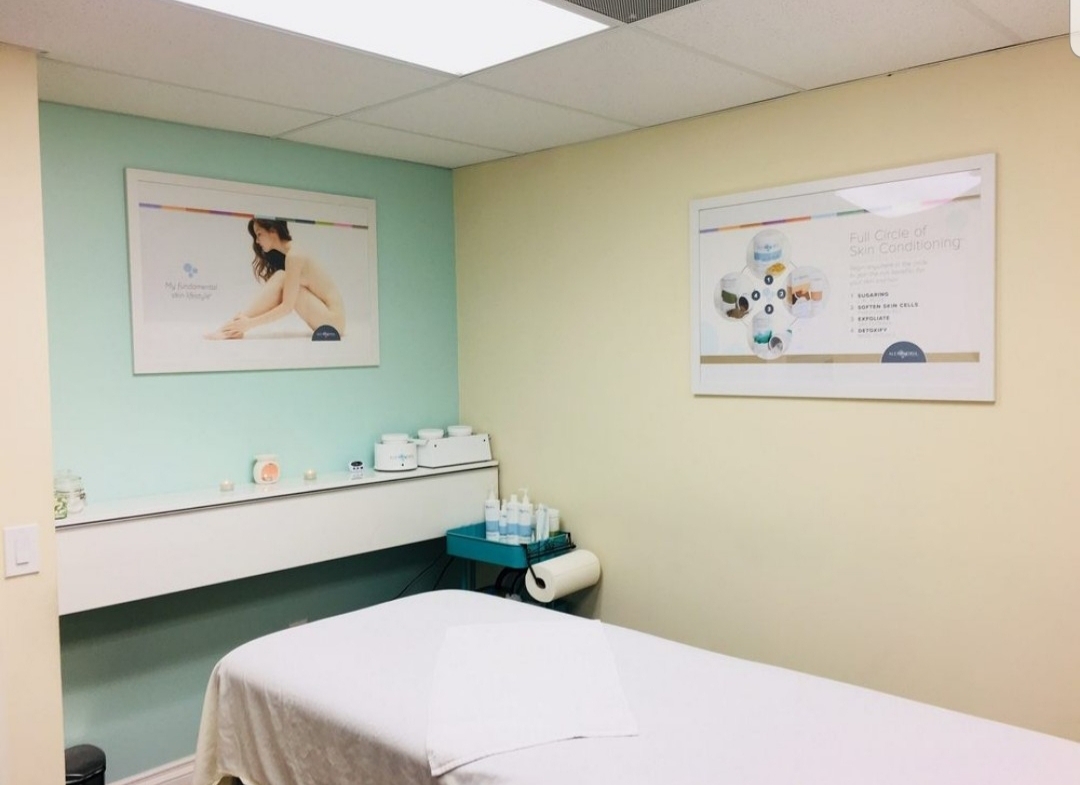 Wellness spa treatment or massage room with relaxing decor and skincare products.