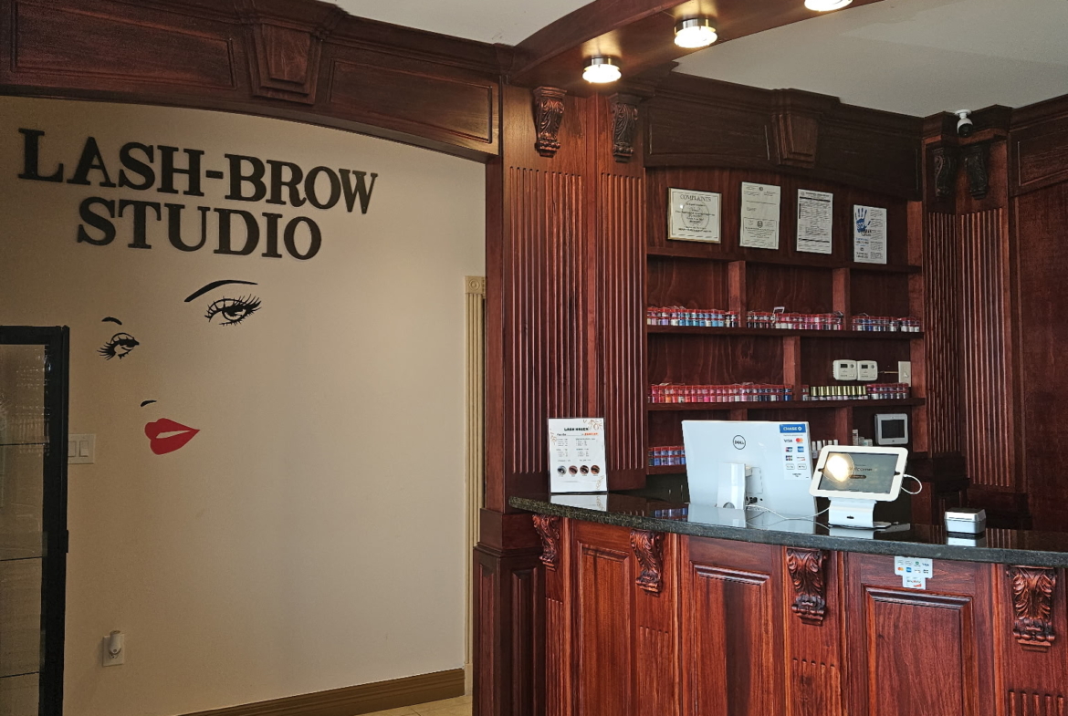 Modern salon reception with stylish wooden counter, seating, and professional atmosphere for beauty renters.