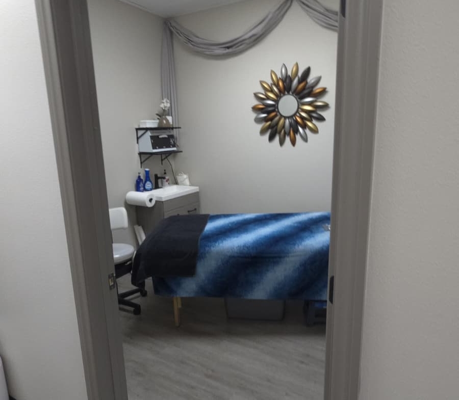 Professional beauty treatment room with massage bed and relaxing ambiance.