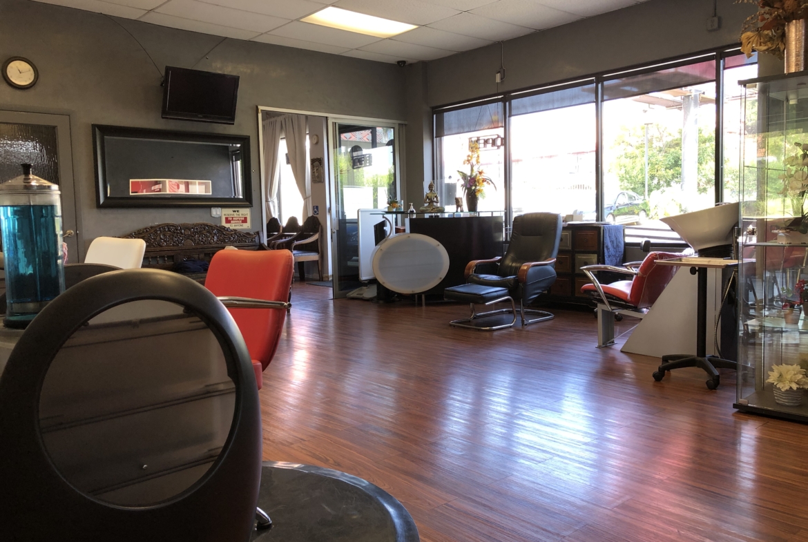 Bright salon with comfortable chairs, large windows, and stylish decor for optimal customer experience.