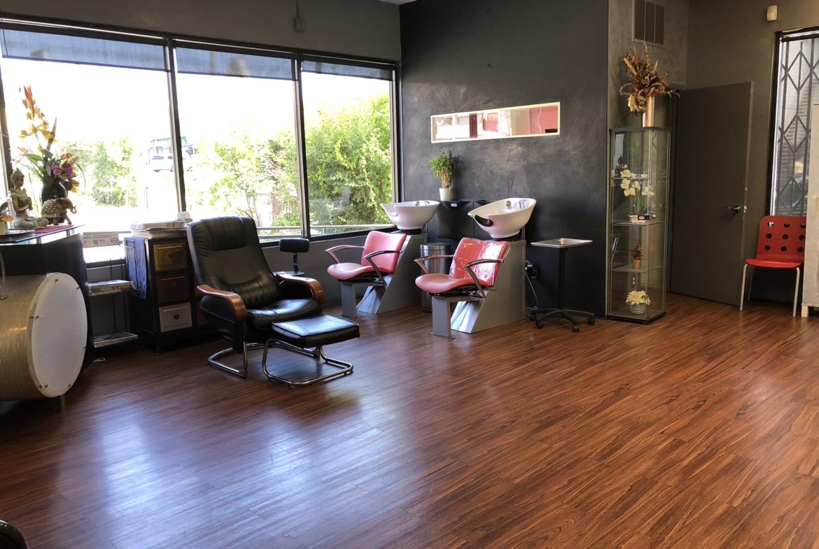 Comfortable hair salon interior with styling chairs and washbasins.