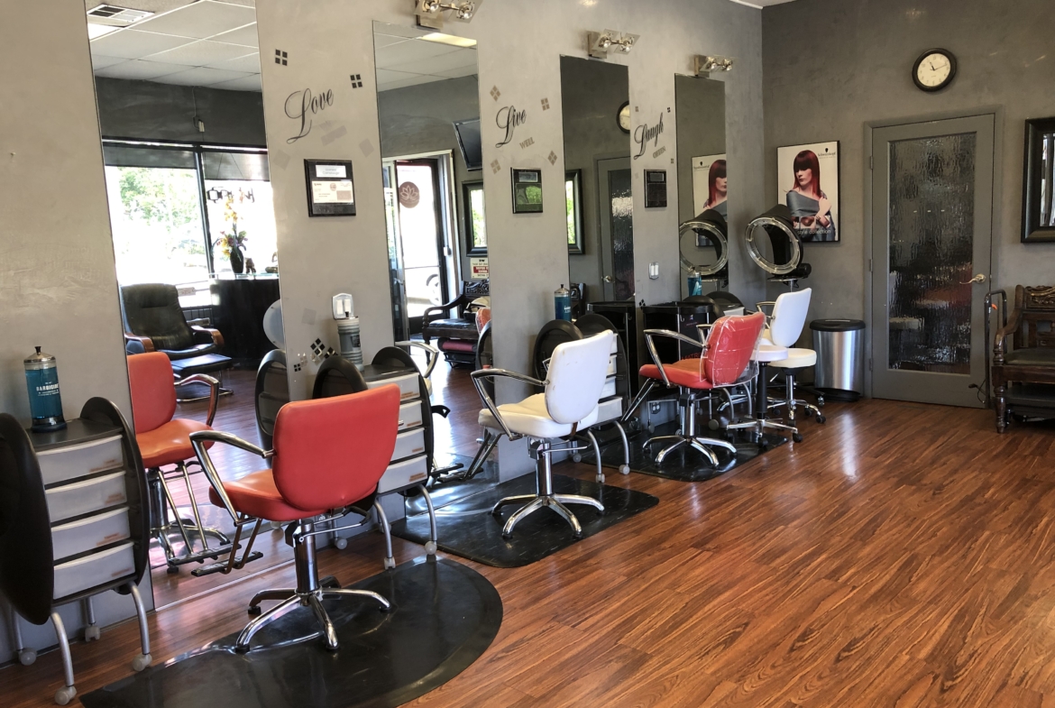 Bright hair salon interior with styling chairs and mirrors for rent or appointment bookings.