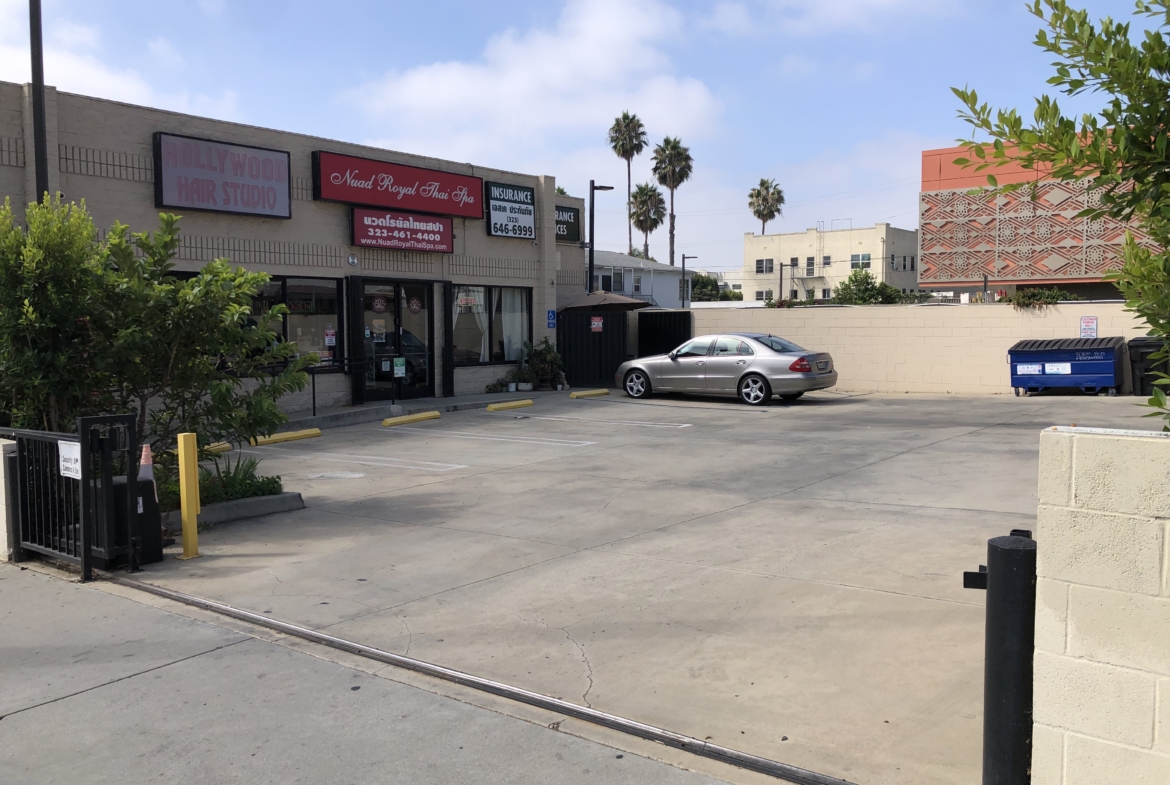 Clean parking area outside salon with one parked car, easy access and visible signage.