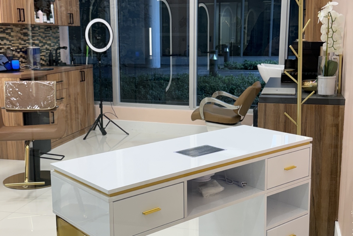 Stylish salon station with modern furniture inside a spacious beauty studio.