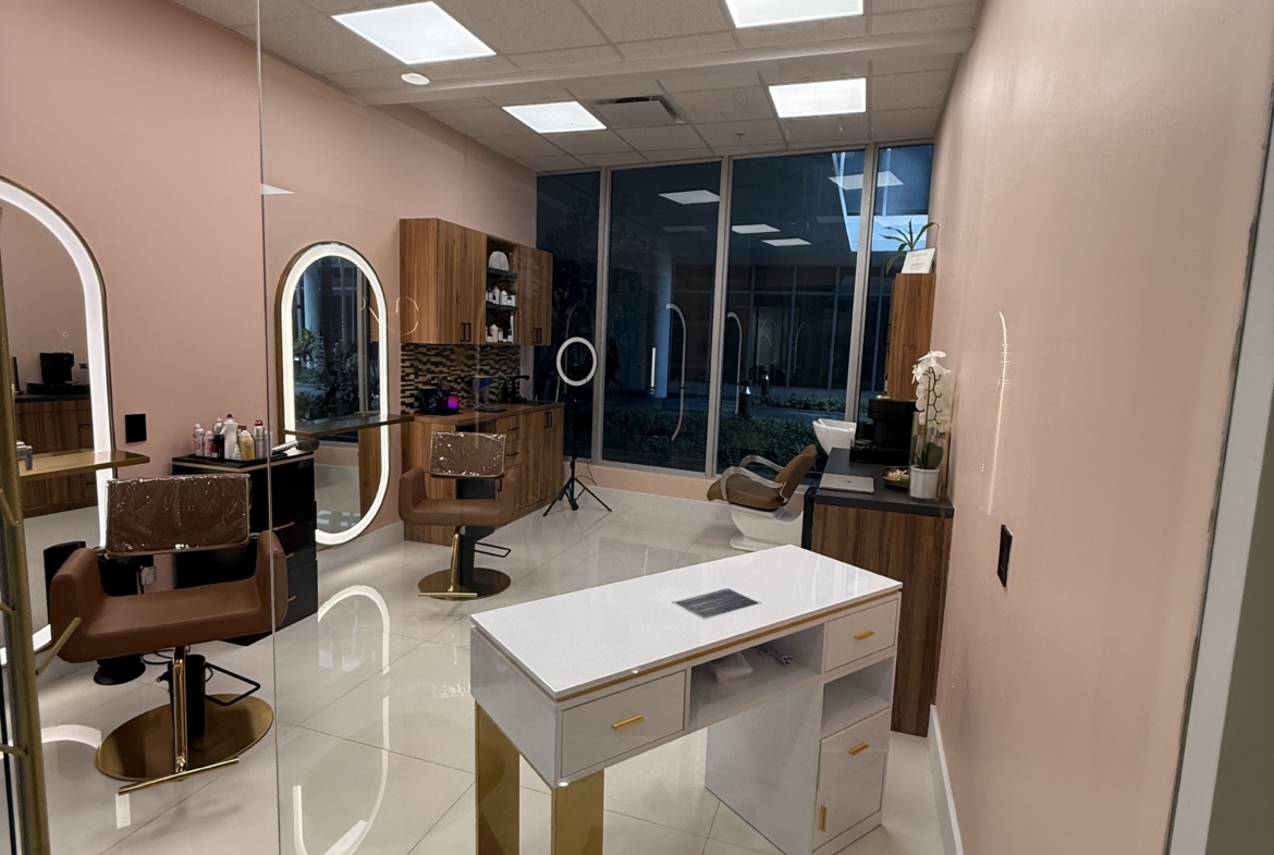 Bright, modern salon interior with mirrors, styling chairs, and large window.
