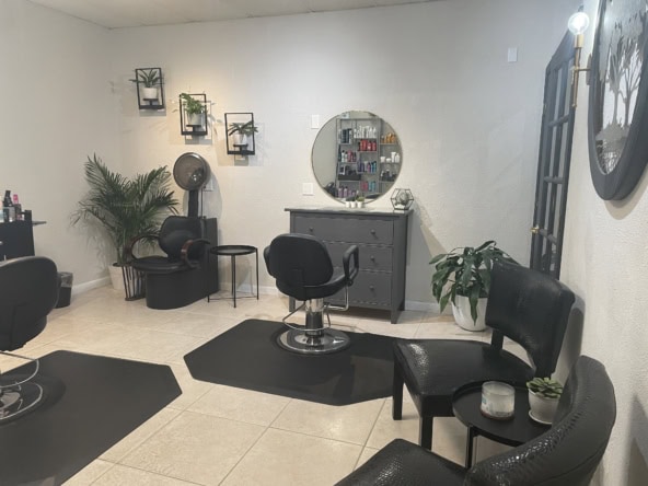 Modern hair salon station with styling chairs, mirrors, and salon essentials.