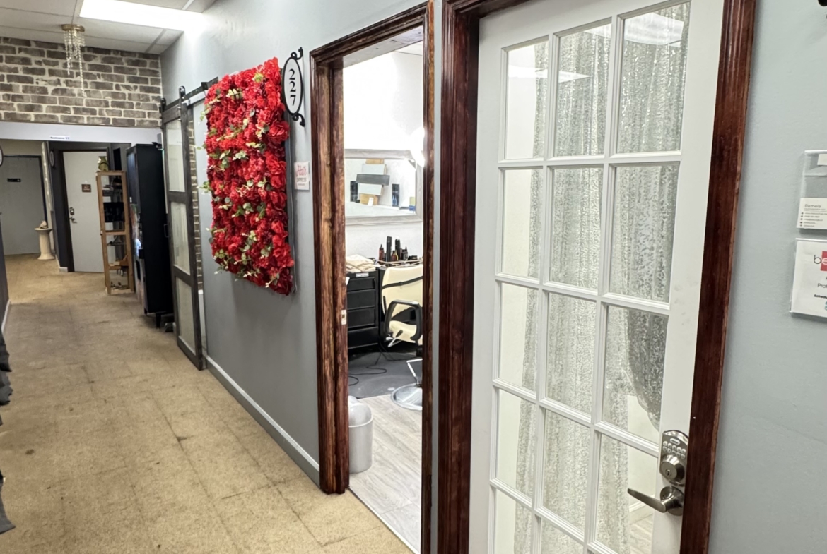 Bright salon space featuring client consultation rooms, stylish decor, and professional setting.