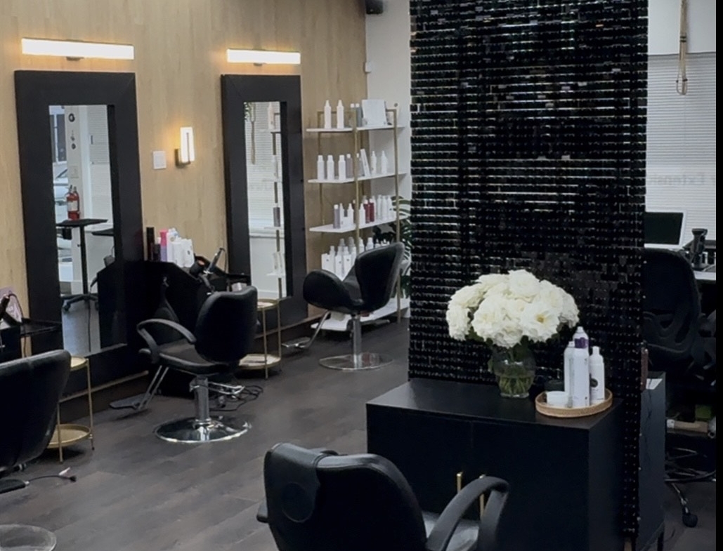 Stylish salon interior featuring hair styling chairs, mirrors, and modern decor.