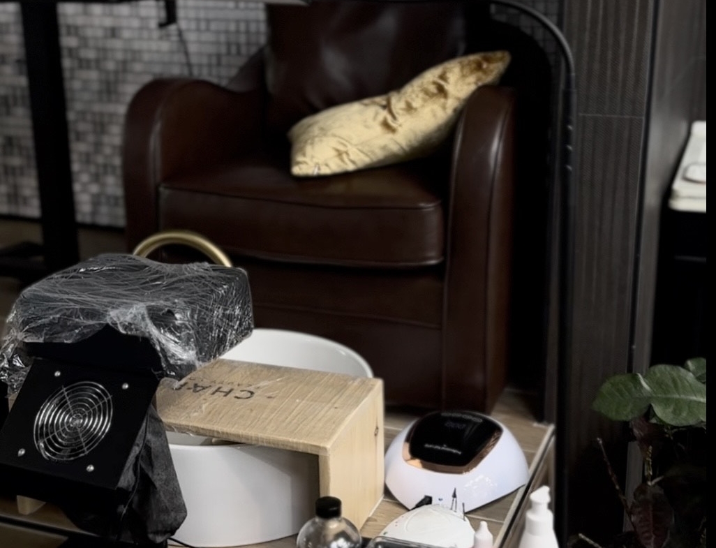 Salon workspace with manicure equipment, nail polish, and accessories in a stylish salon environment.