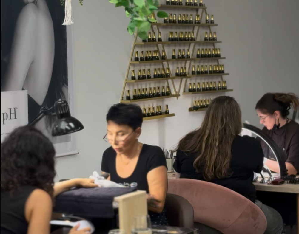 Relaxing nail salon with professional technicians, modern decor, and premium nail products.