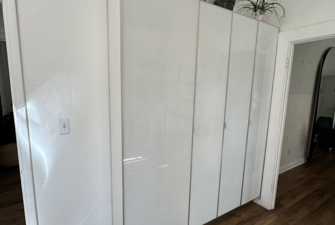 Modern white storage cabinet for salon or studio use.