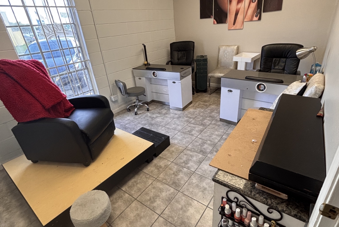 Modern salon interior with nail stations, manicure supplies, and a comfy waiting area, perfect for beauty professionals.