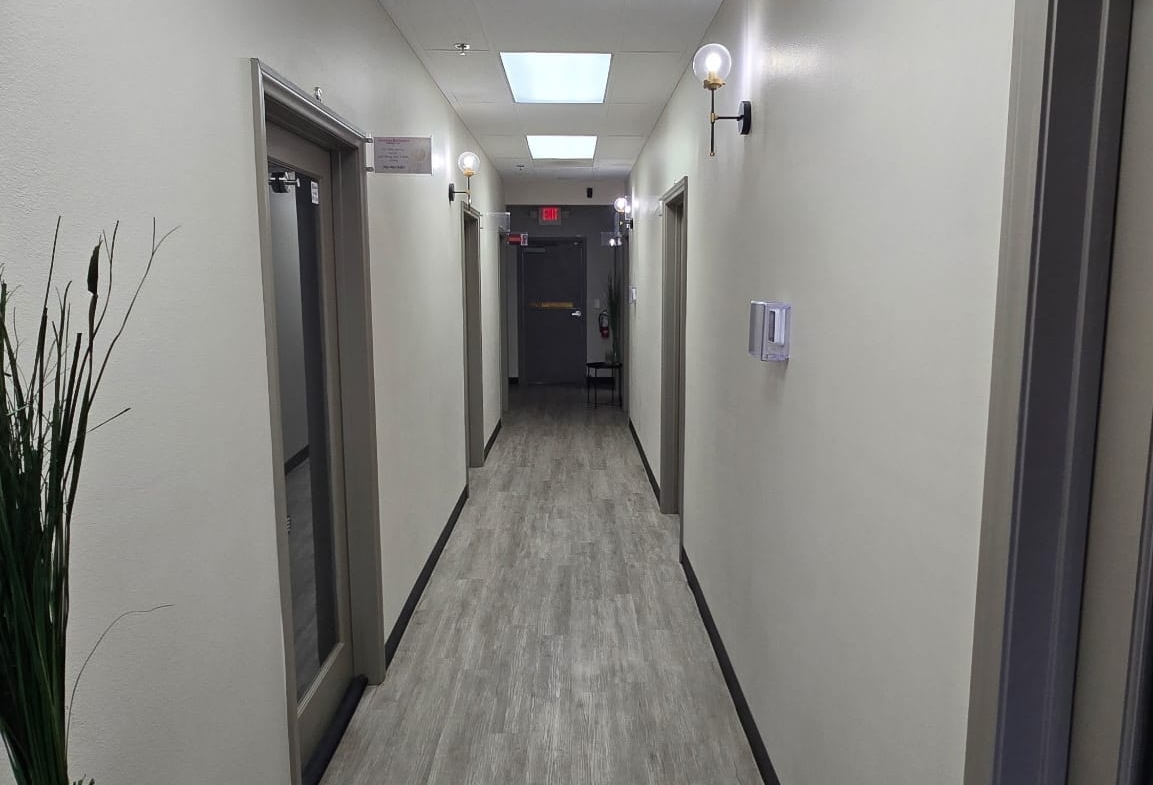 Bright hallway in a professional salon or spa, featuring modern lighting and clean design.