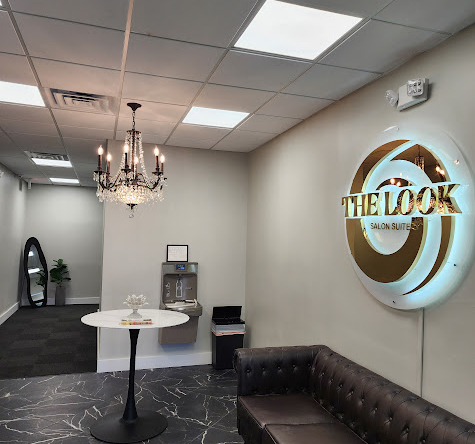 Modern salon reception area with stylish decor and a comfortable lounge.