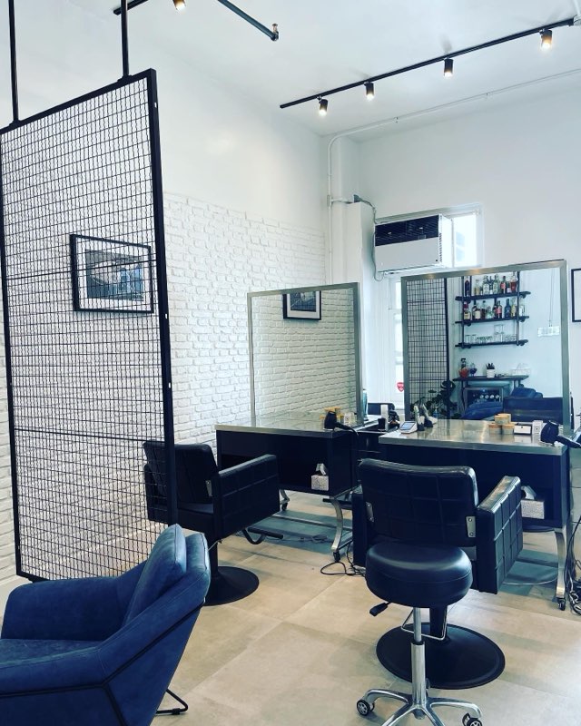 Stylish salon station with mirrors, chairs, and beauty supplies for rent.