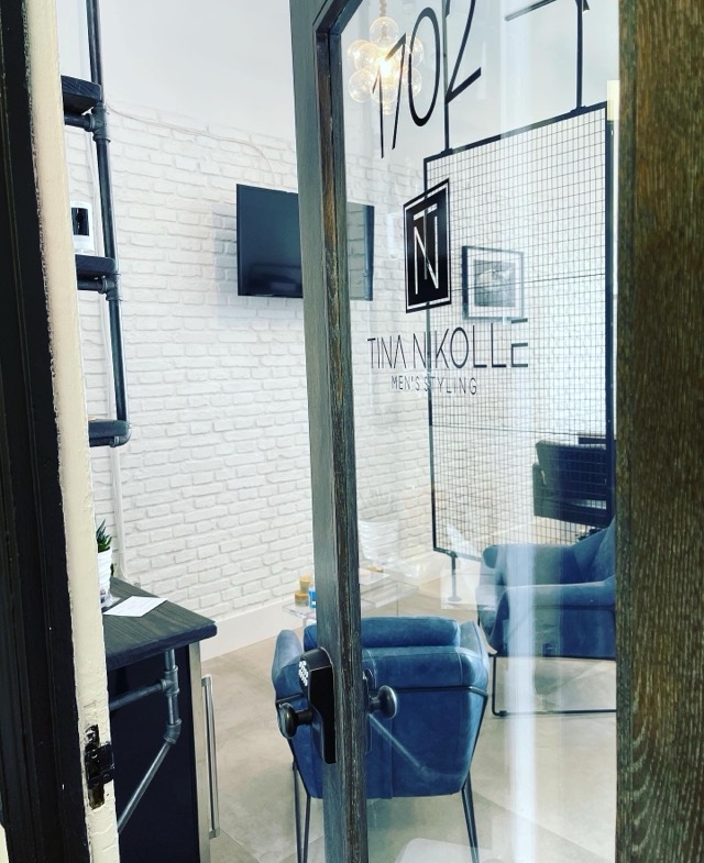 Modern salon rental space with stylish decor and cozy seating areas.