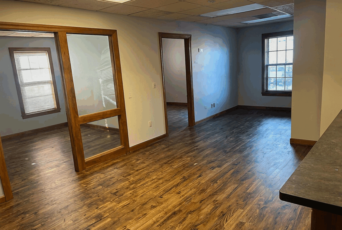 Bright, spacious salon space with wooden accents, perfect for stylists and beauty professionals.