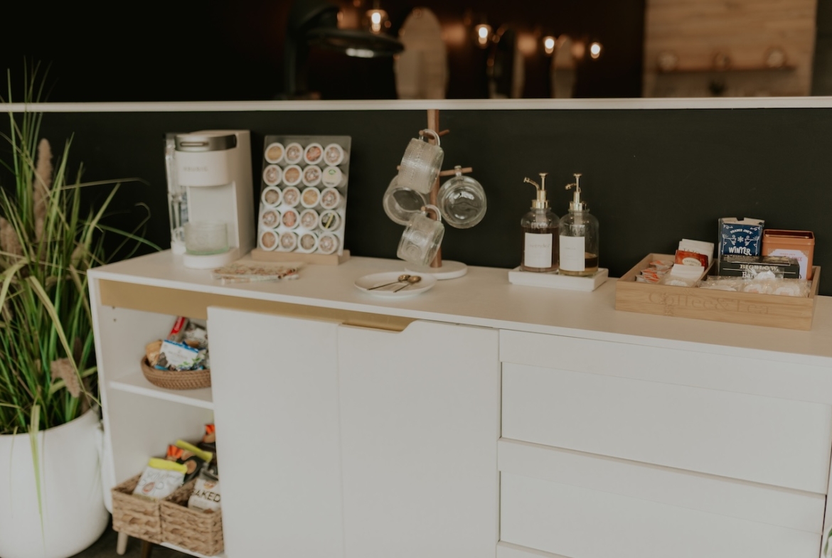 Well-organized salon space with coffee station and supplies for beauty professionals.