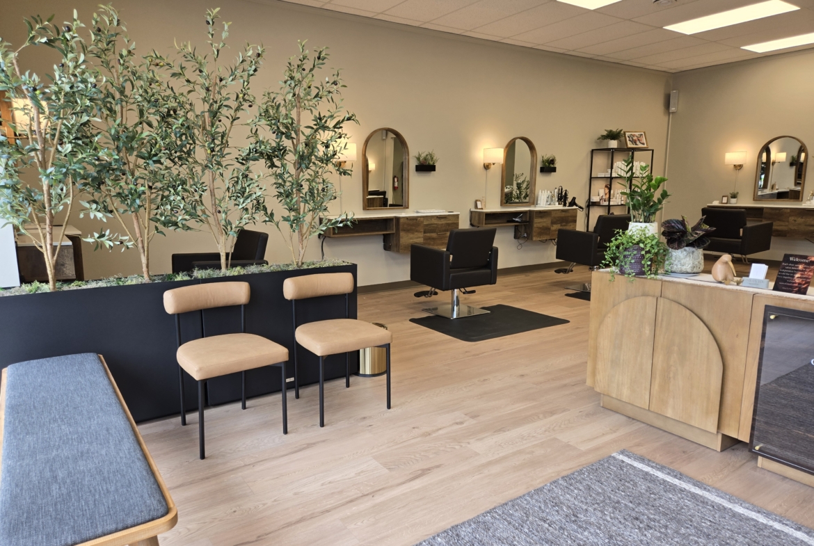 Stylish salon interior with comfortable seating, mirrors, and plants for a welcoming vibe.