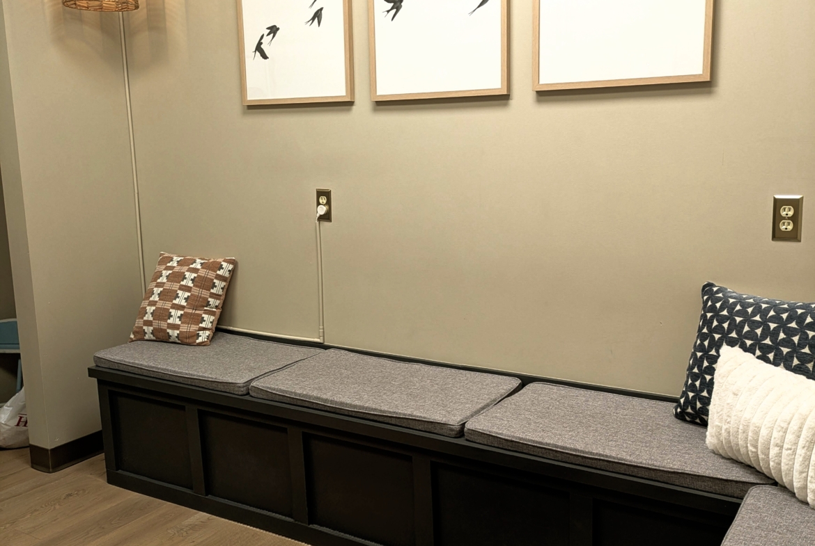 Comfortable salon lounge with seating, decorative pillows, and stylish decor.