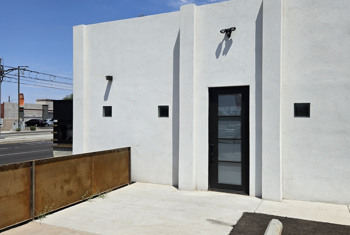 Clean, minimalist salon rental storefront with parking space.