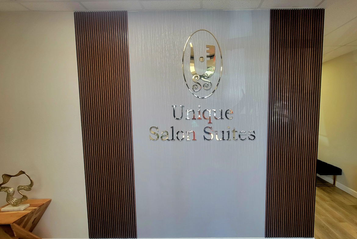 Elegant salon suite sign in a professional wellness environment.