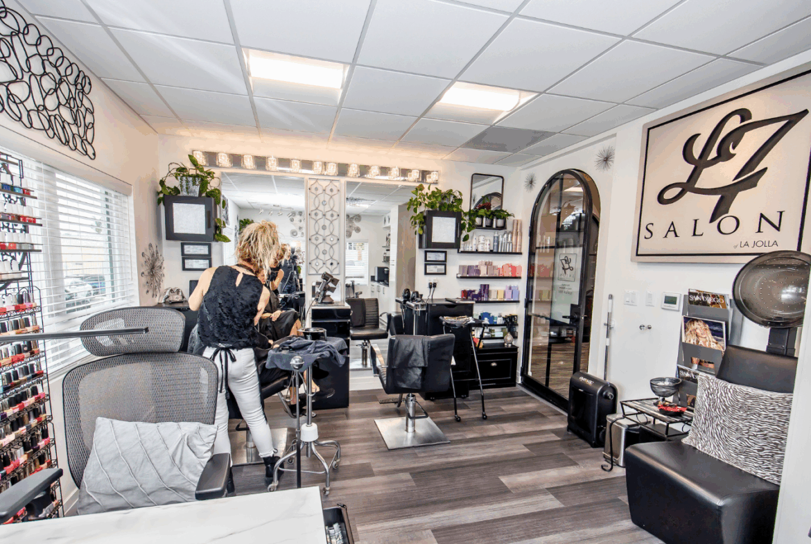 Bright salon space with modern decor, styling stations, and nail polish displays for rent.