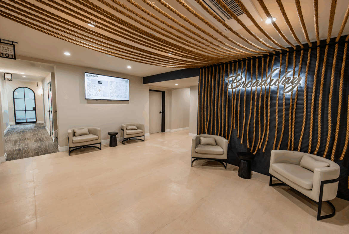 Bright, stylish salon lobby featuring modern decor, comfortable chairs, and branding for a professional salon environment.
