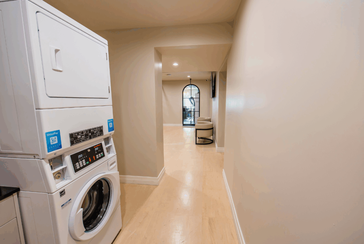 Modern laundry space in salon with washing machine and dryer for easy customer services.