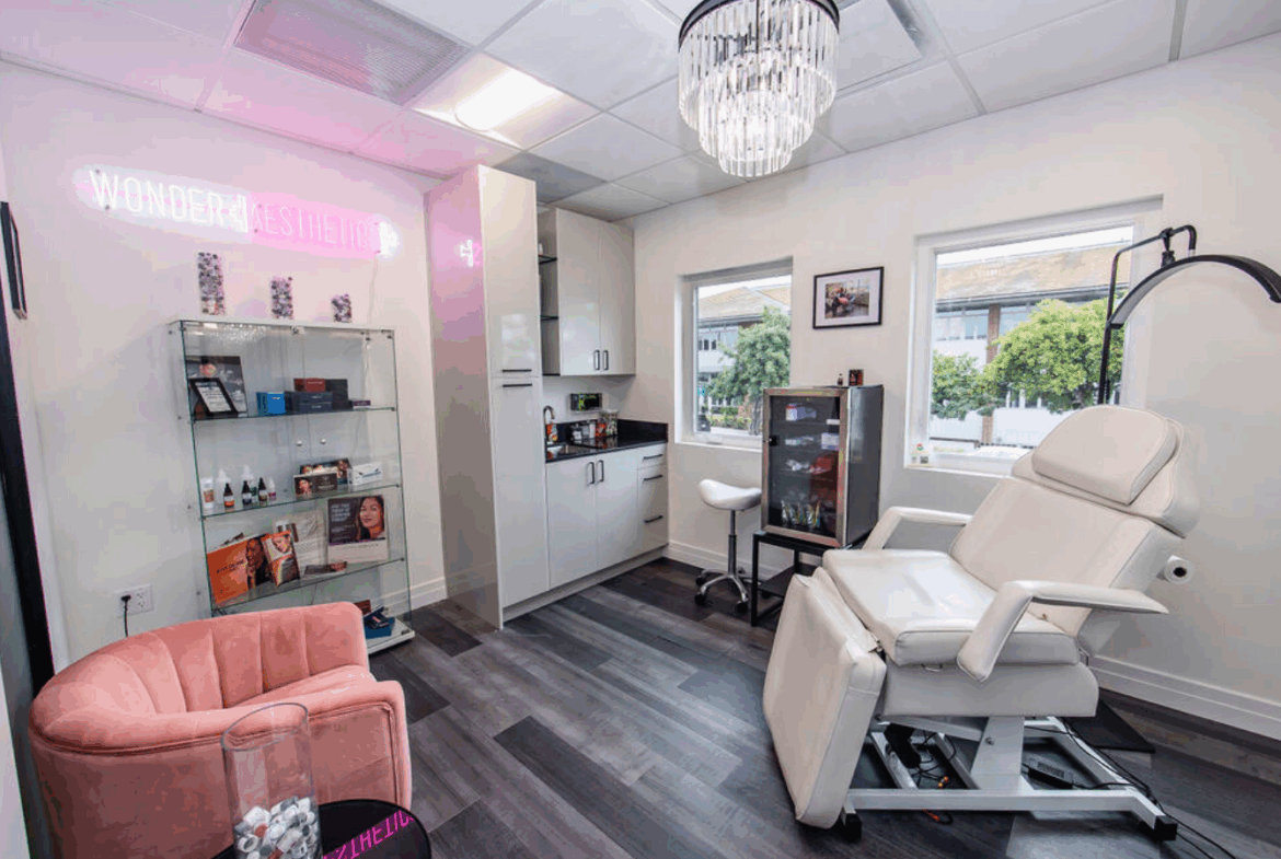 Relaxing salon treatment room with massage chair, skincare products, and bright natural light ambiance.