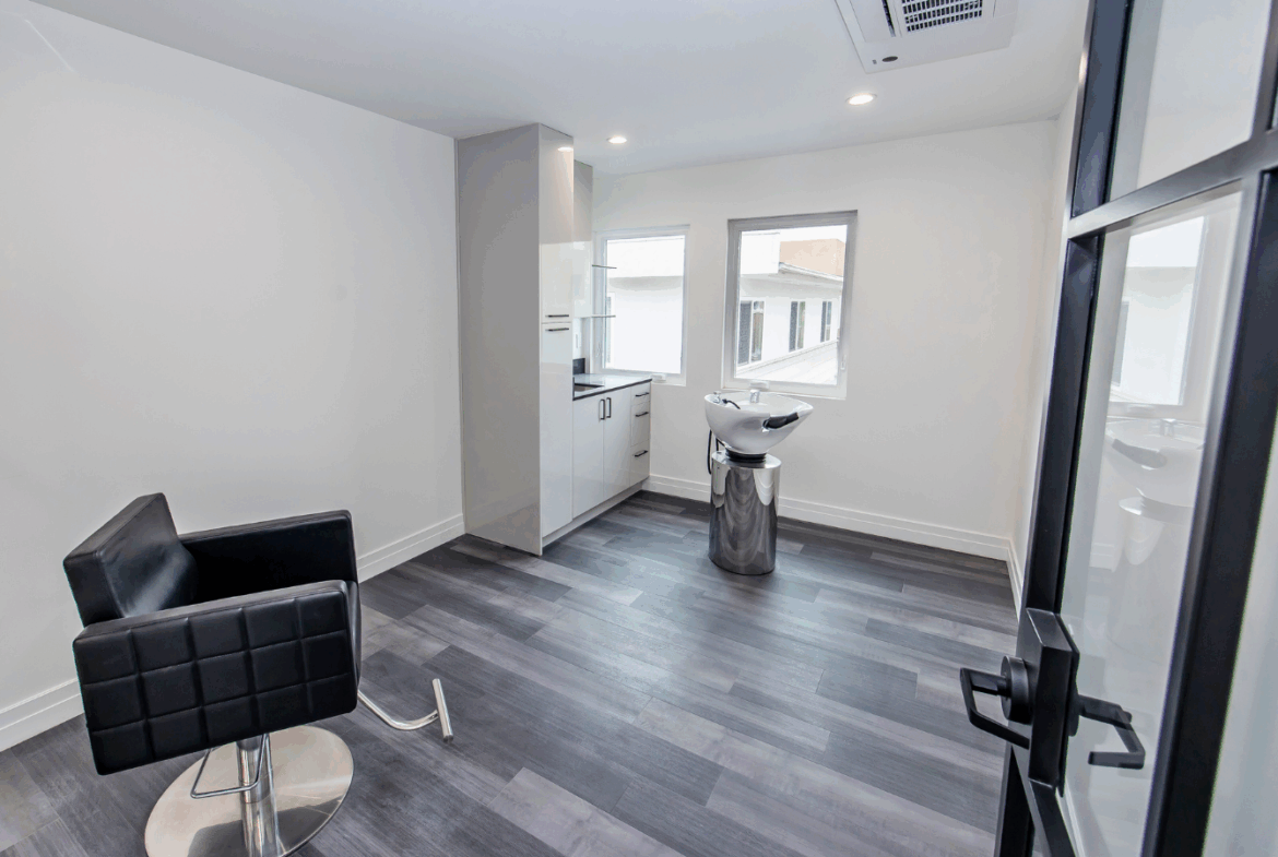 Stylish salon workspace with hair station, styling chair, and natural light for client comfort.