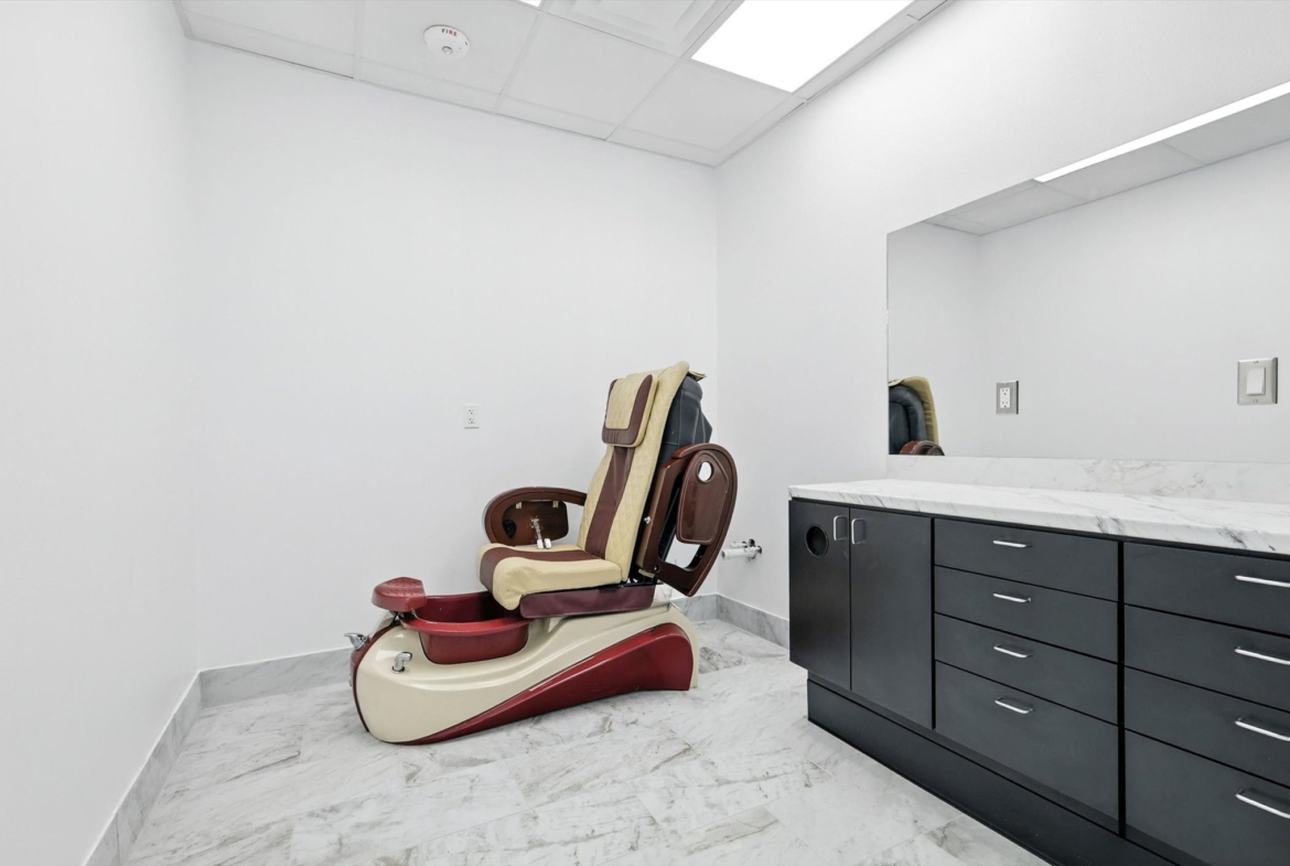 Comfortable salon chair with adjustable features in a minimalist, professional salon environment.